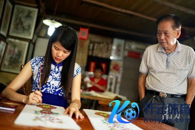 刘钟萍与师傅冯炳棠在创作。